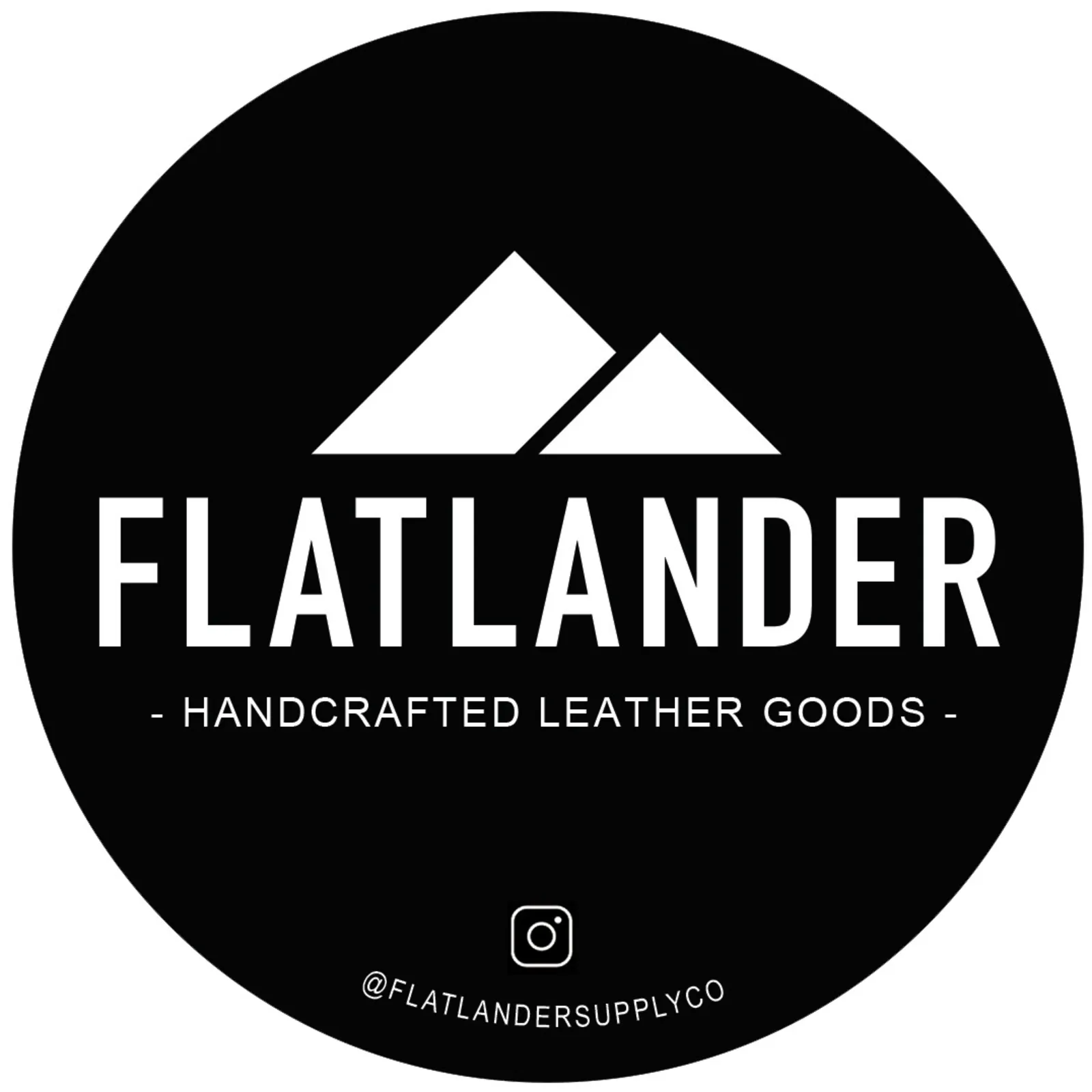 Flatlander Supply Co. badge in black — two-peak mountain mark over a condensed FLATLANDER wordmark, with the strapline Handcrafted Leather Goods