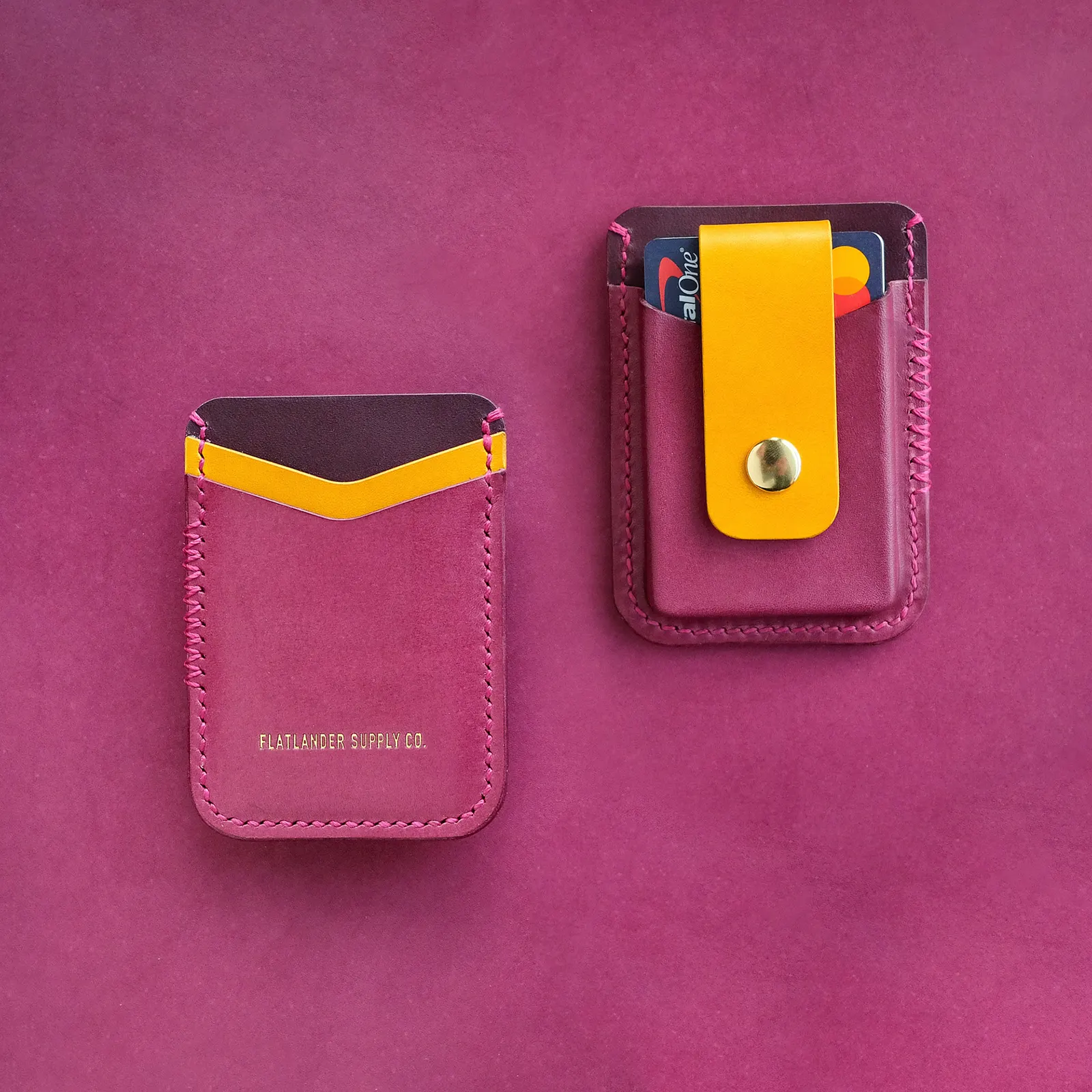 A magenta card sleeve and matching money clip on a magenta leather hide