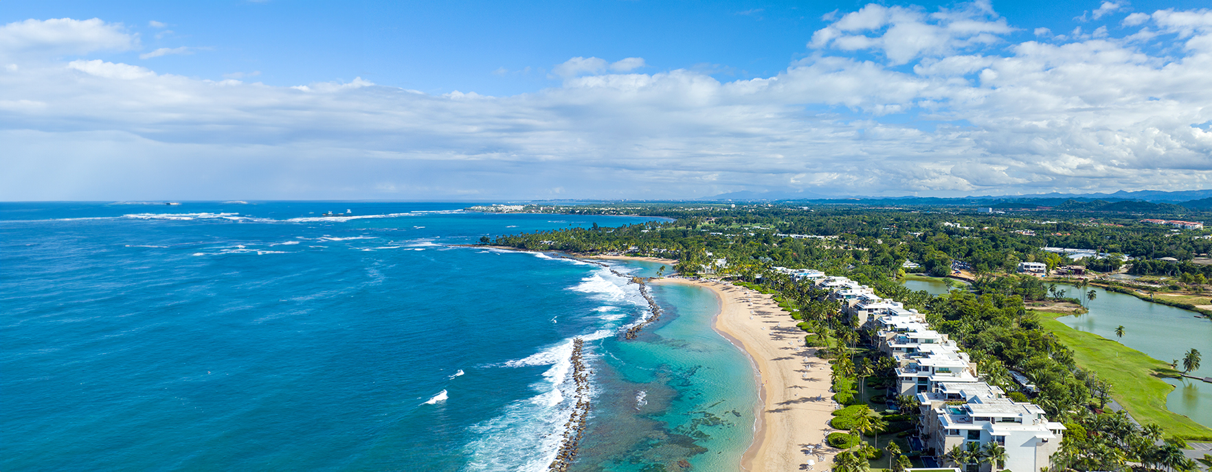 Aerial view of Dorado, Puerto Rico coastline — turquoise water, white sand, and luxury residences